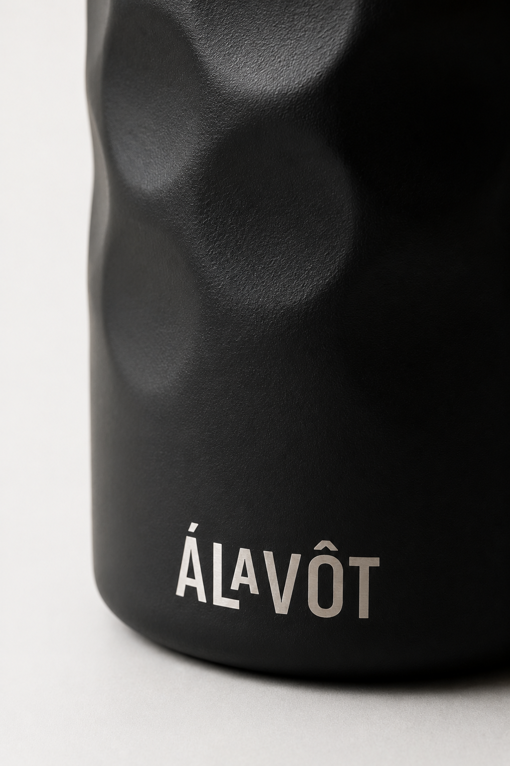 BClose up of a black Insulated wine cooler with etched Alavot logo on white background