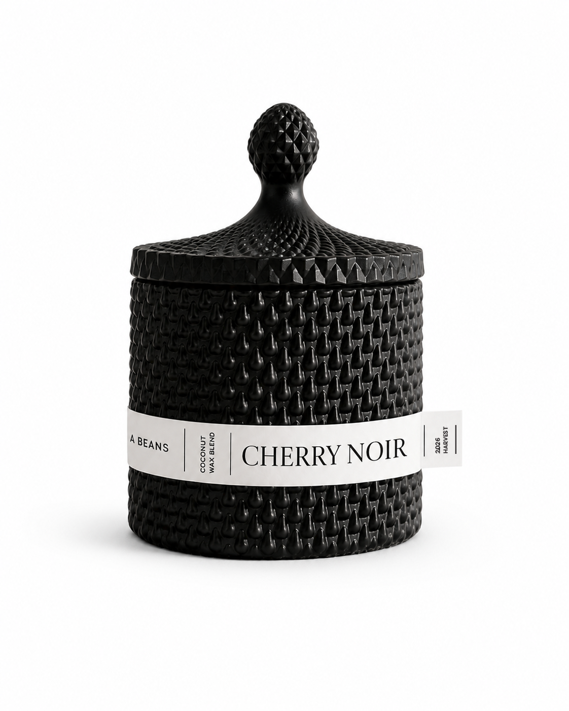 Black textured scented candle with 'Cherry Noir' label on a white background