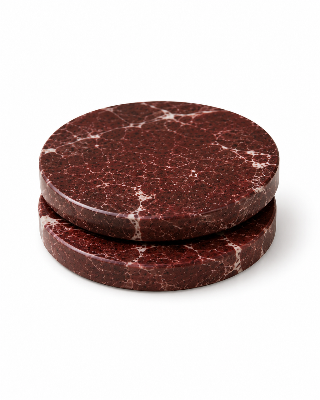 Two stacked red marbled circular coasters on a white background
