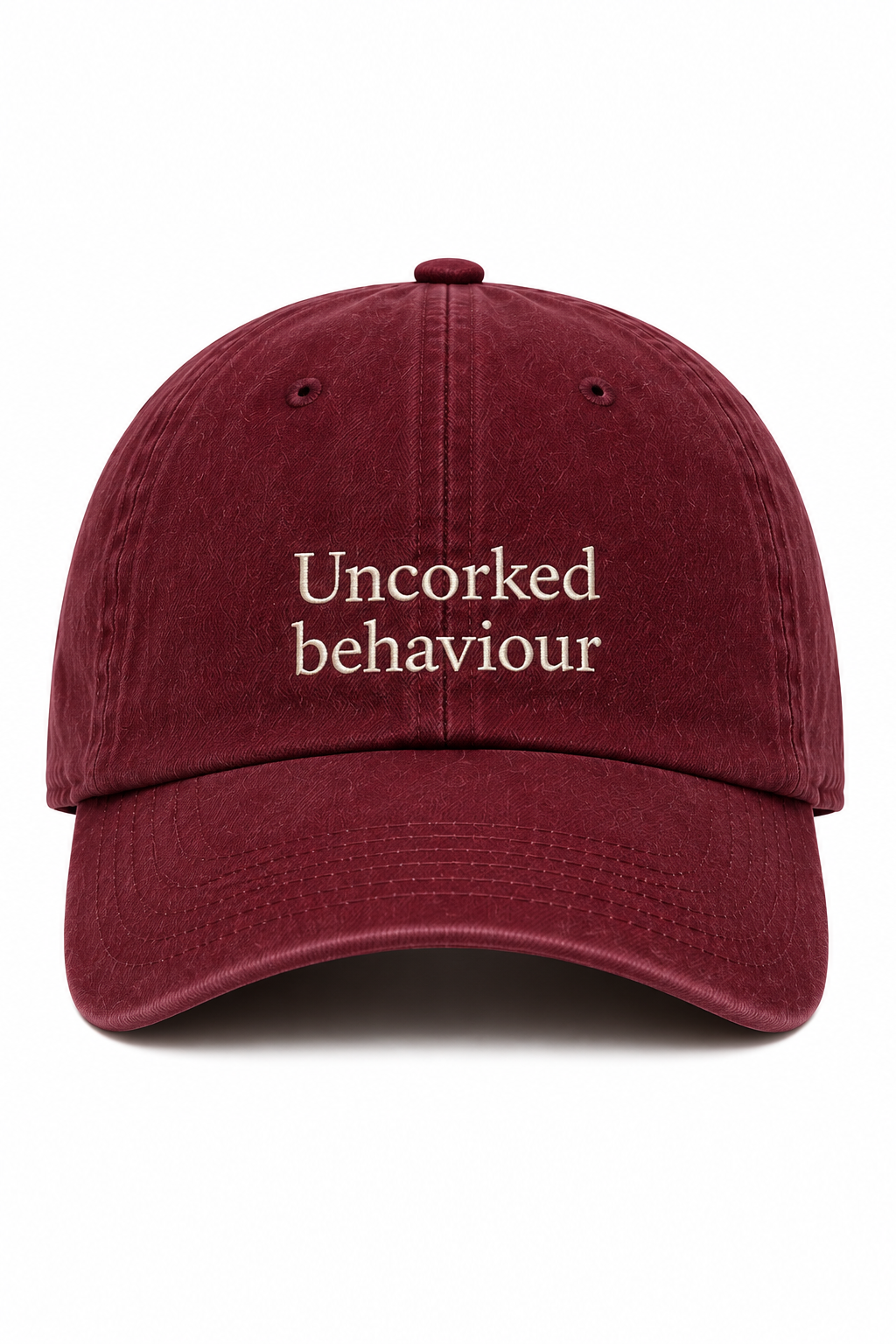 Maroon  burgandy cap with 'Uncorked behaviour' embroidered text on a white background 