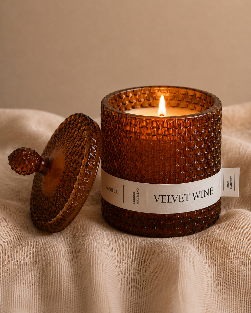 Scented Candle labeled 'Velvet Wine' with a textured brown lid on a beige fabric background. Alavot